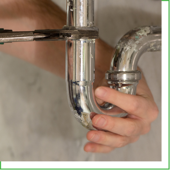 plumber working under sink