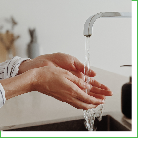 woman running hands under faucet