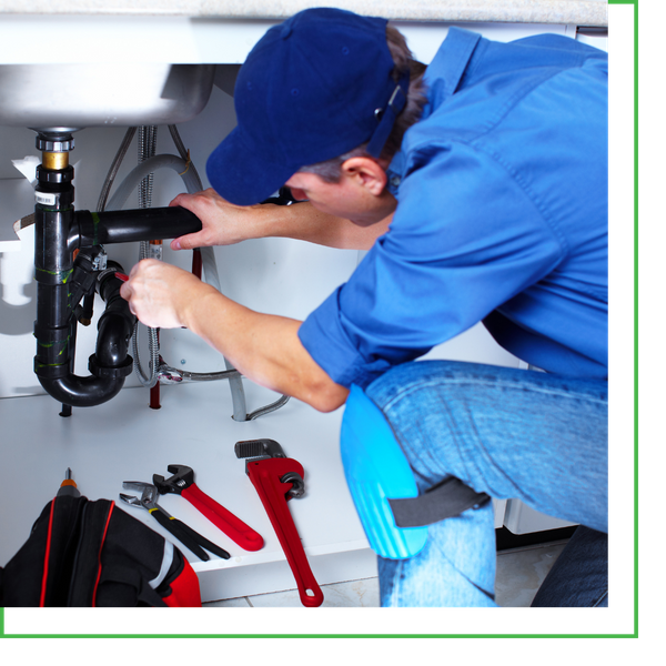 plumber working under sink