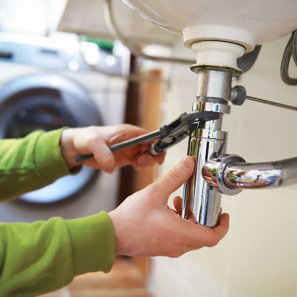 plumber working on sink