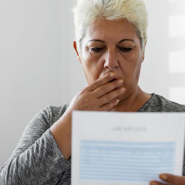 woman looking over water bill