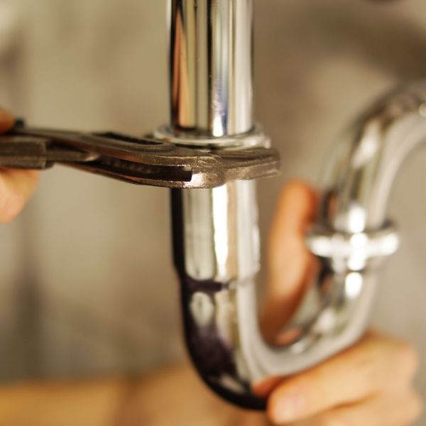 A plumbing pipe being tightened 