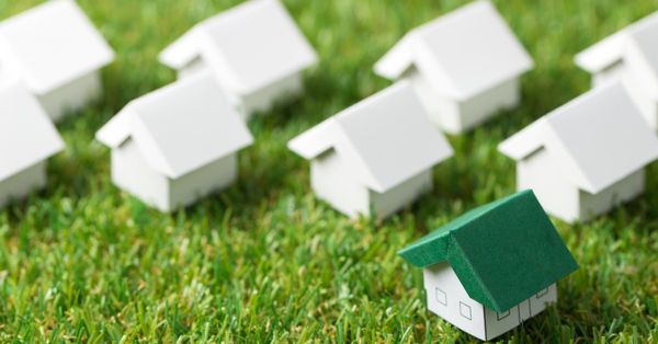 Model homes lined up on grass 