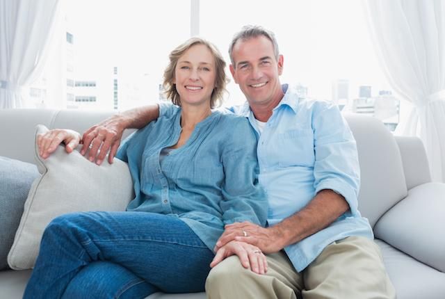 couple sitting on couch smiling