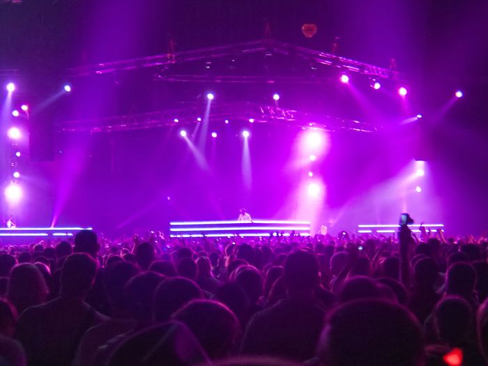 Large stage with a crowd of people.