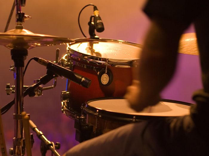 Drummer playing the drums at a concert. 