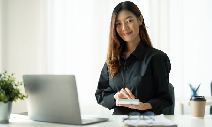 woman with laptop smiling