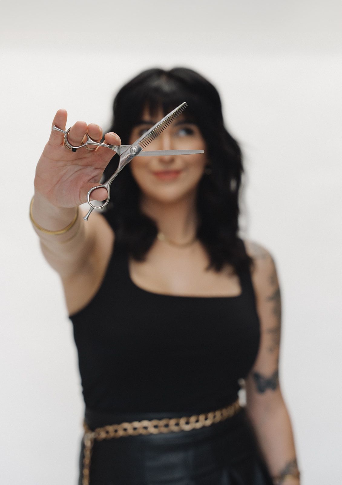 Stylist holding scissors at Haus of FIDI Pensacola