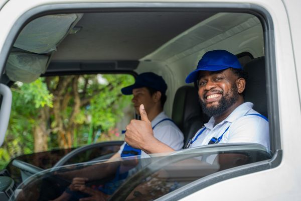 mover in moving truck with thumbs up