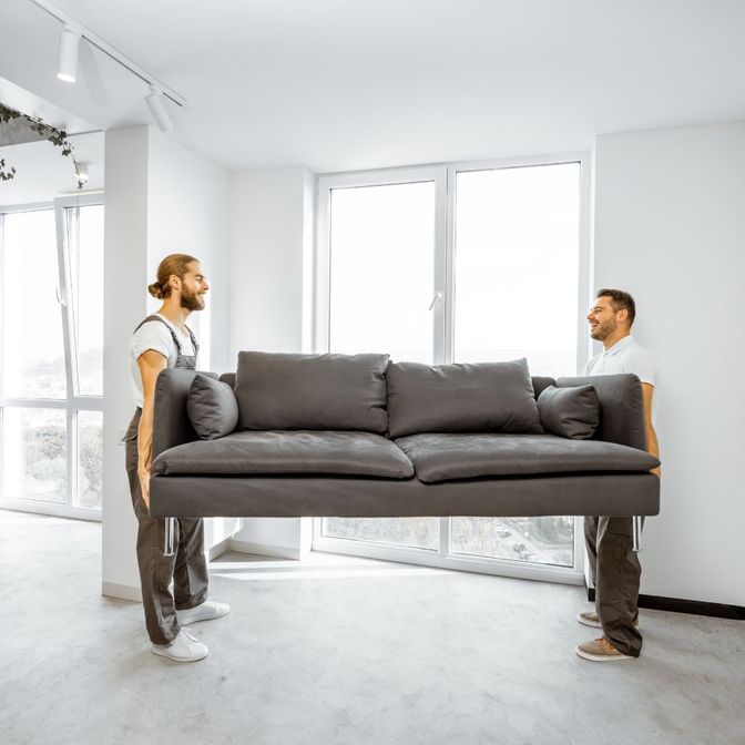 Movers holding sofa couch
