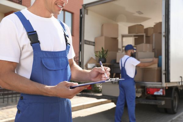  movers packing things in a moving truck