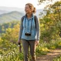 An active middle-aged woman hiking in the Virginia mountains, representing metabolic energy and health.