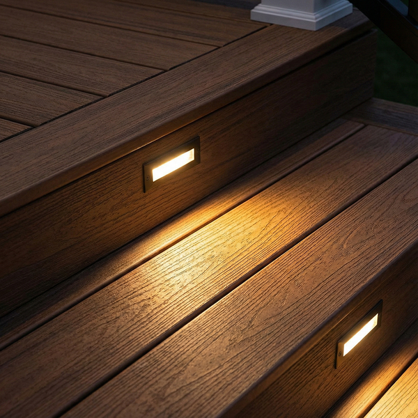 Warm LED riser lights provide safety and ambiance on composite deck steps at night.