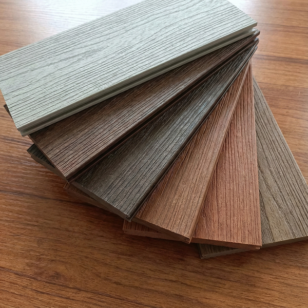 A fan of composite decking samples showcasing a variety of color and texture options.