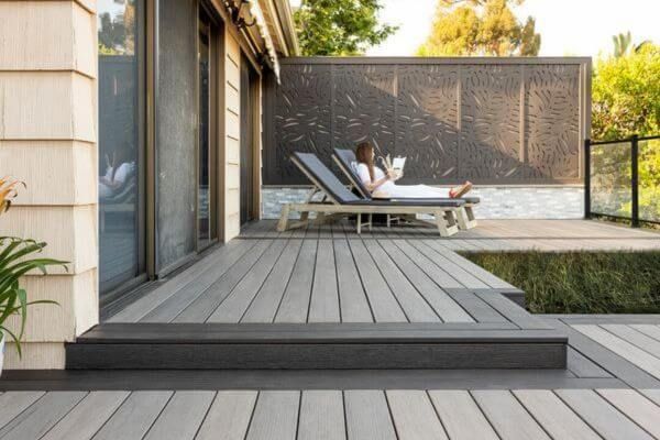 woman on cozy backyard deck woman on cozy backyard deck