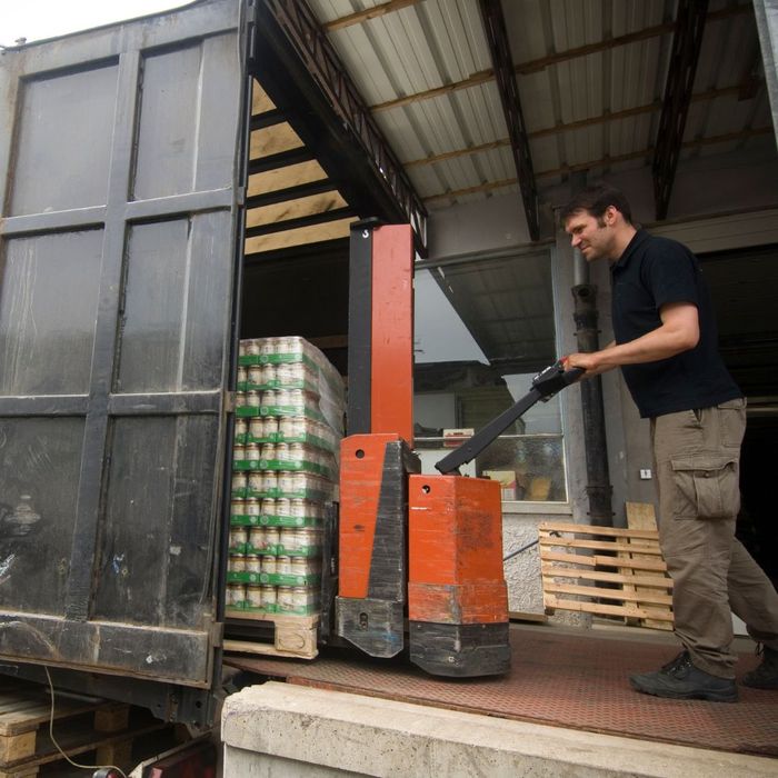 loading custom pallet with products on to a truck