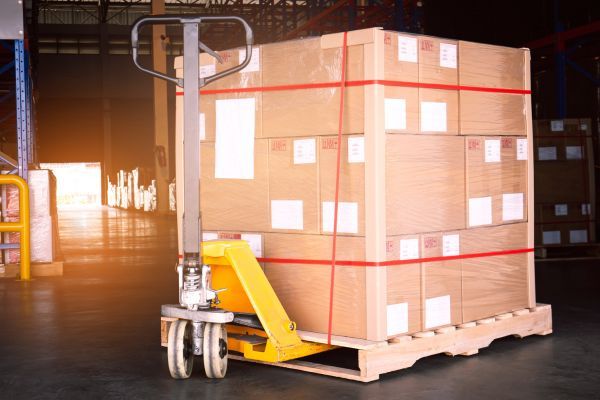 wood pallet with pallet jack in warehouse