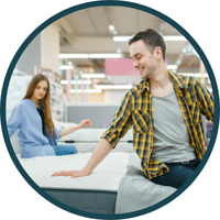 couple testing mattresses in store