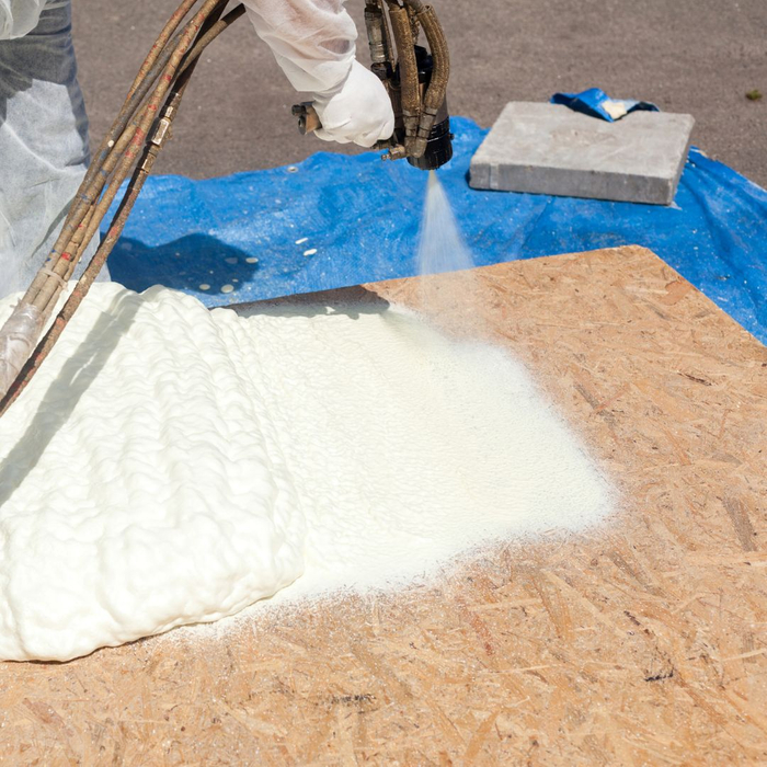 contractor using spray foam insulation gun