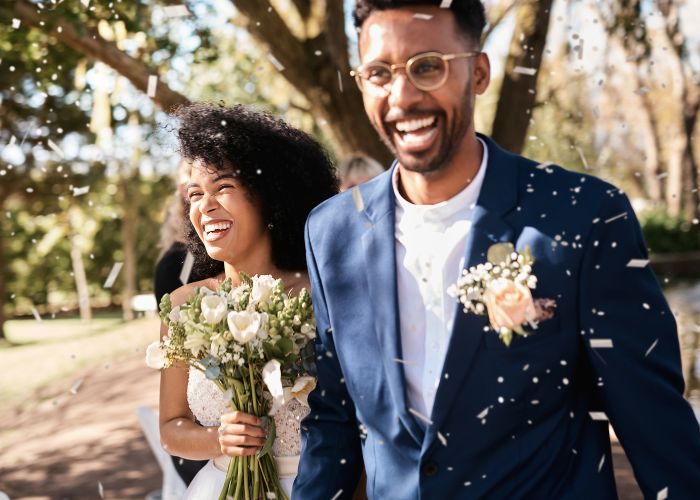 A happy newlywed couple walking down the aisle 