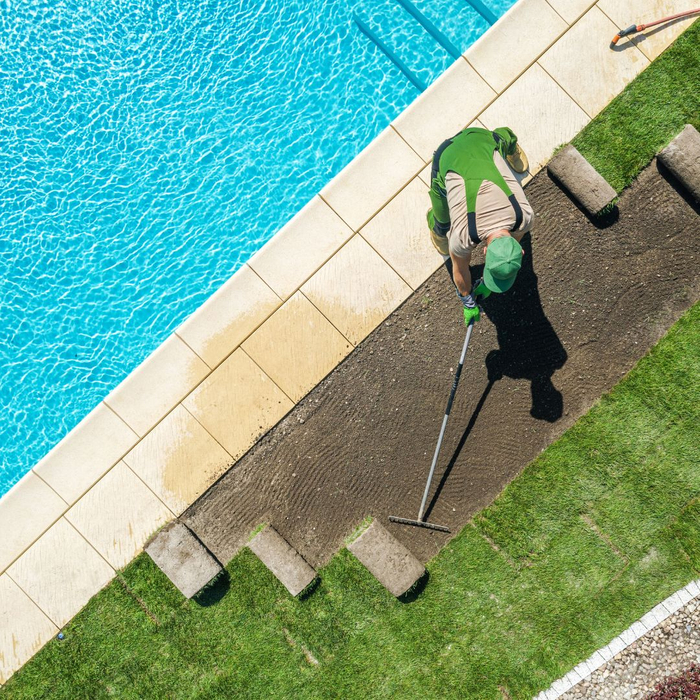installing grass near pool