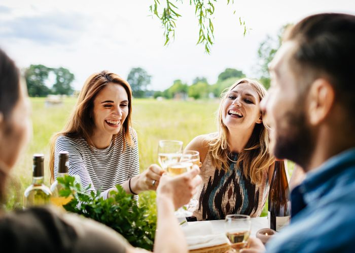 A group of happy people sitting outdoors at a party