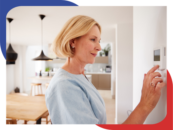 Woman chaning a thermostat