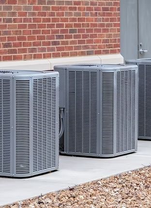 Horizontal-shot-of-commercial-air-conditioners-outside-near-a-maintenance-door_.jpg