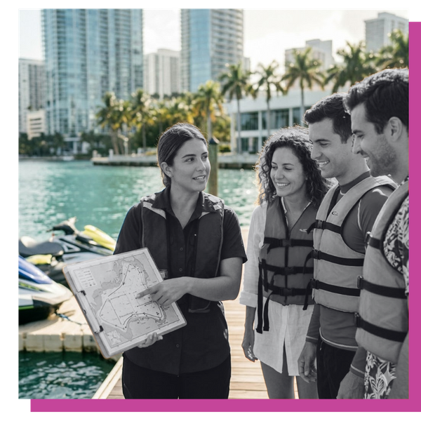 A professional Miami jet ski guide providing a safety briefing to vacationing tourists before their water adventure