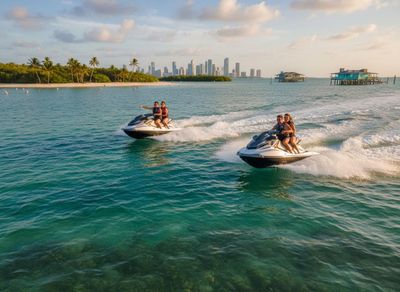 Couples jet skiing in tropical waters with city skyline