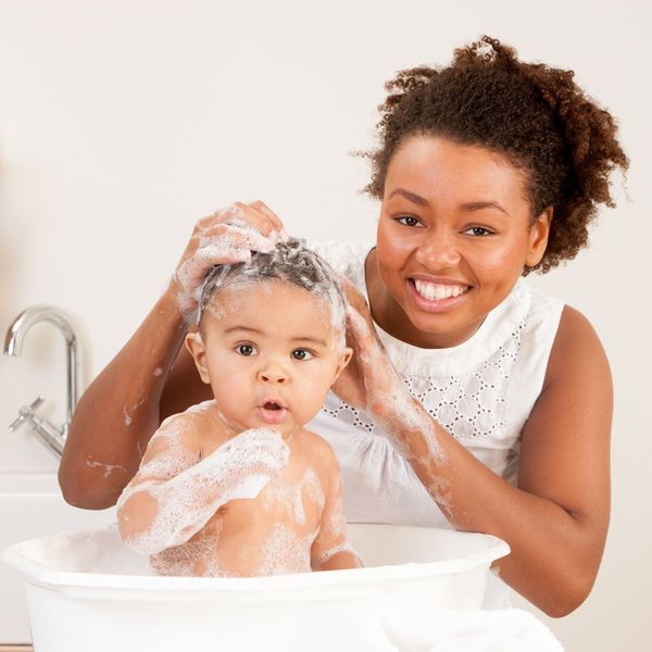 a woman bathing her baby