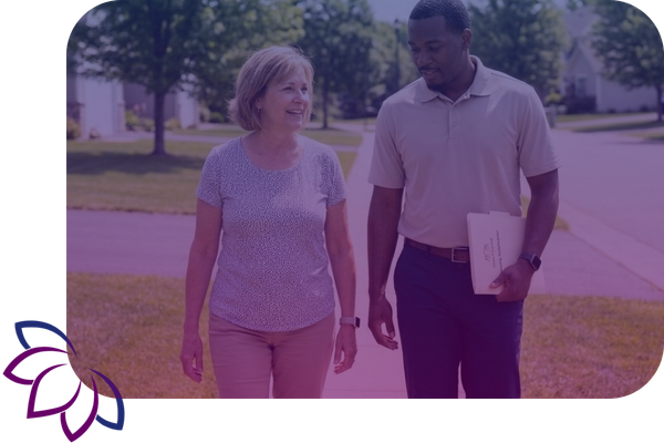 support worker walks outdoors with a client