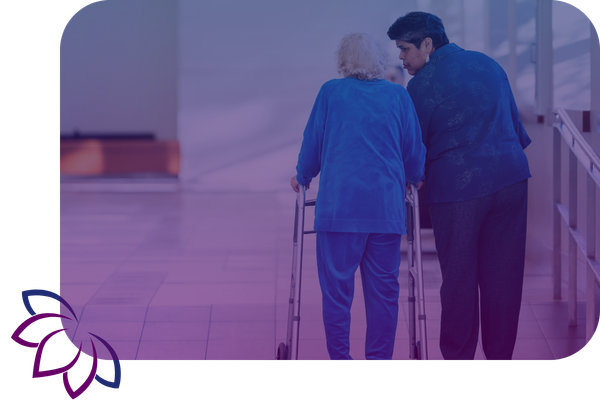 woman helping woman with walker