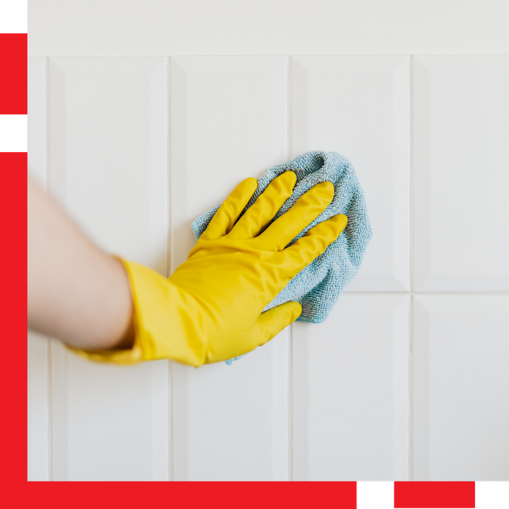 Person Cleaning White Tile with Cloth