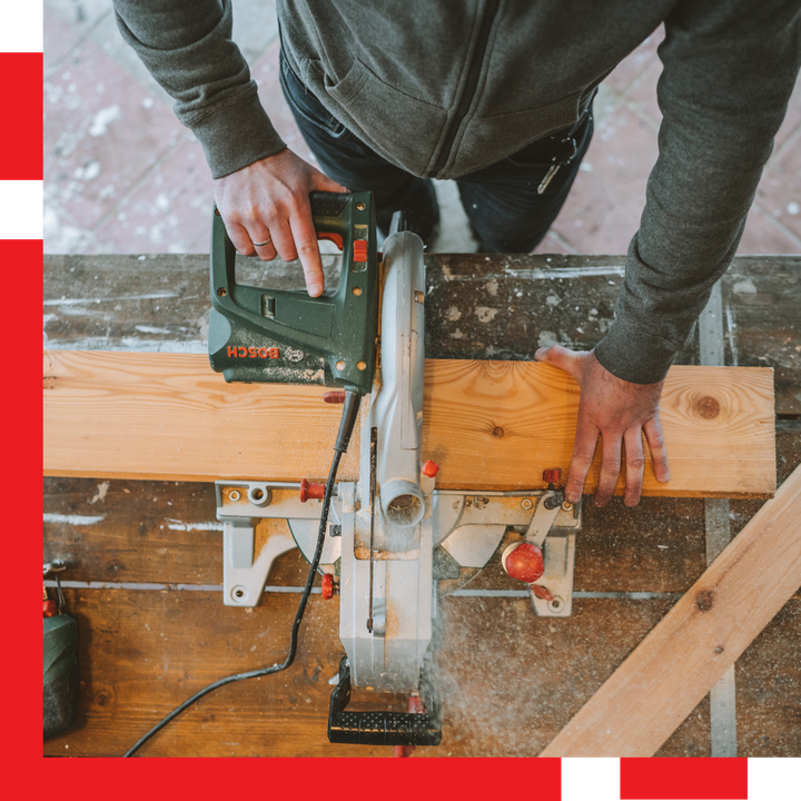 Man Using Table Saw to Cut Wood Plank