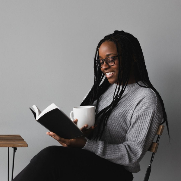 woman reading Bible drinking coffee