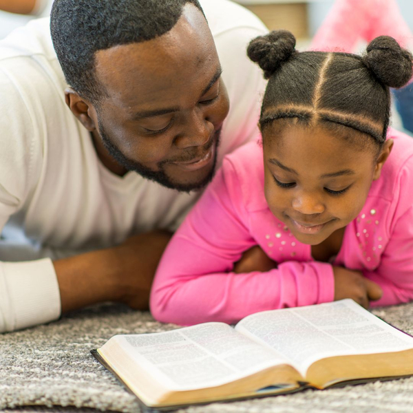 daddy and daughter reading Bible
