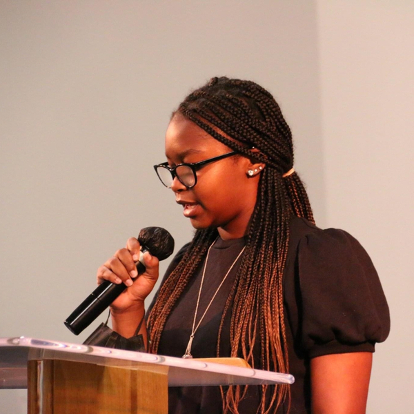young woman speaking to congregation