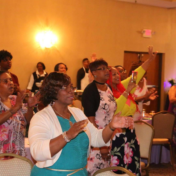 The women of The Sanctuary at Kingdom Square worshipping.
