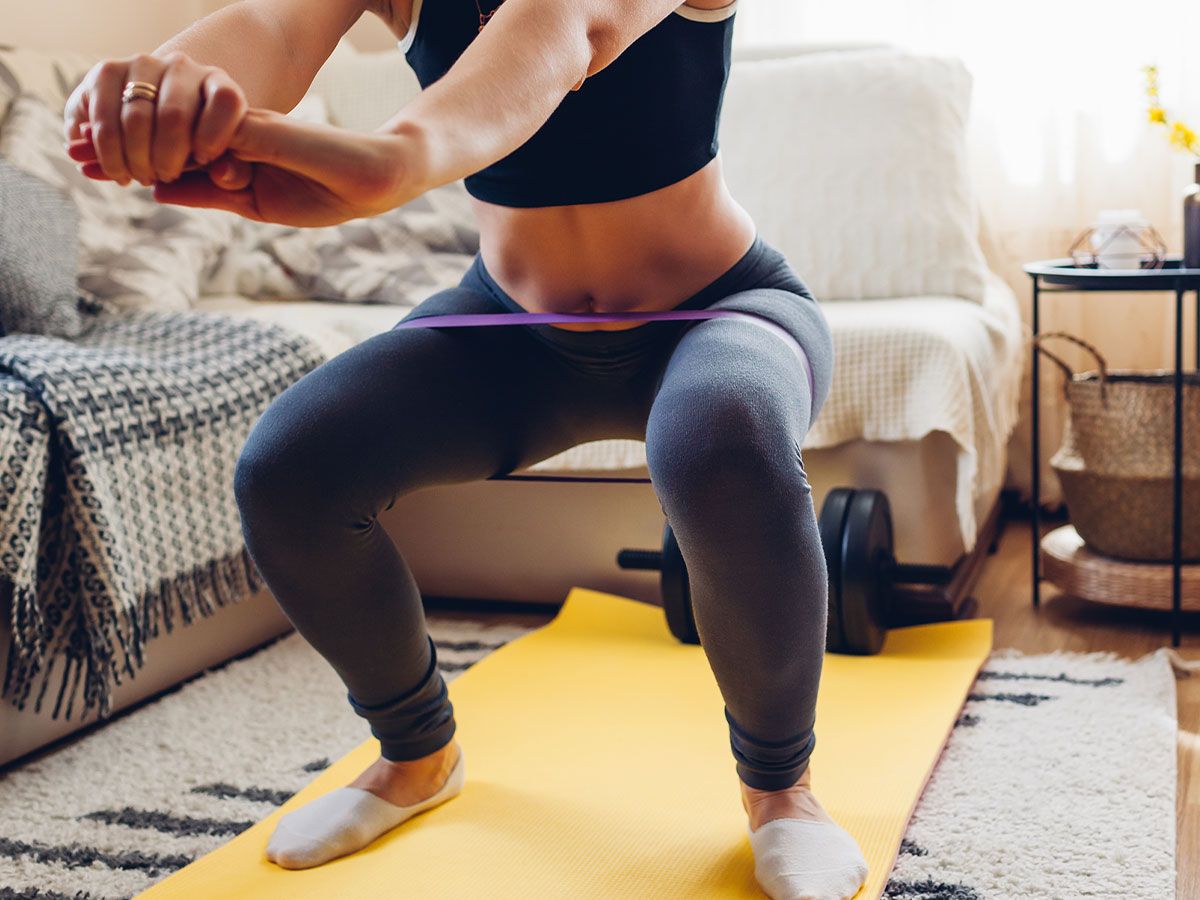 Woman doing home workout with resistance bands