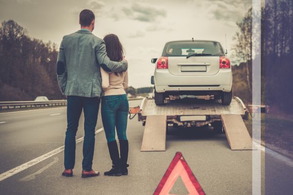 car being towed on the highway