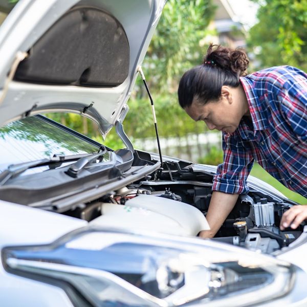 looking under the hood at overheated car