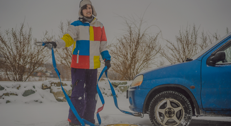 man on the side of the road with a tow rope. 