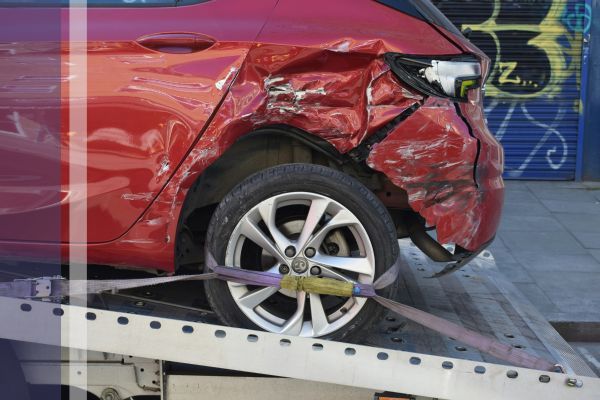 car with damage that is being towed