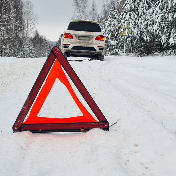 pulled over on snowy road with cone 