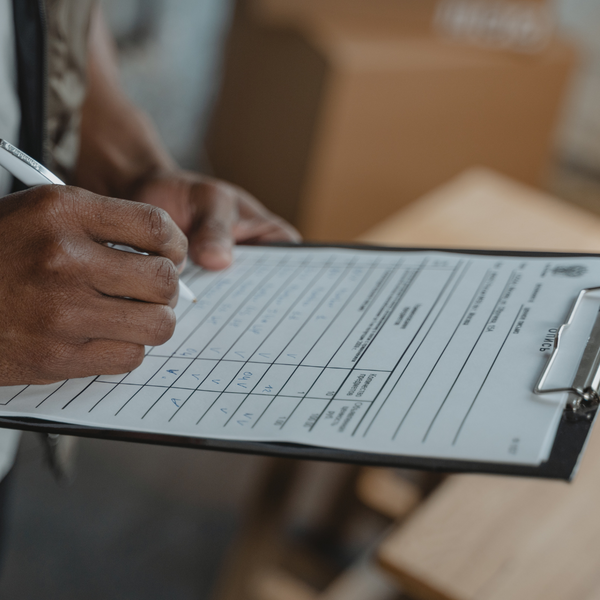 person filling out paperwork. 