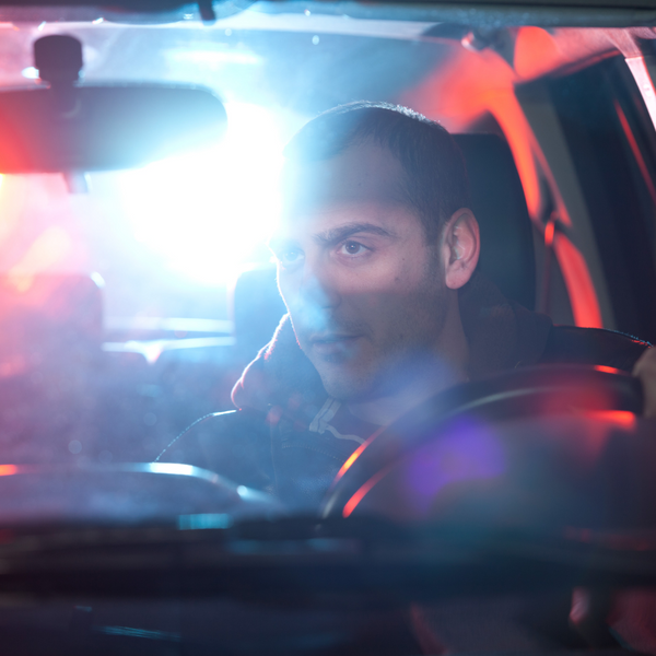 man sitting in his car in the dark. 