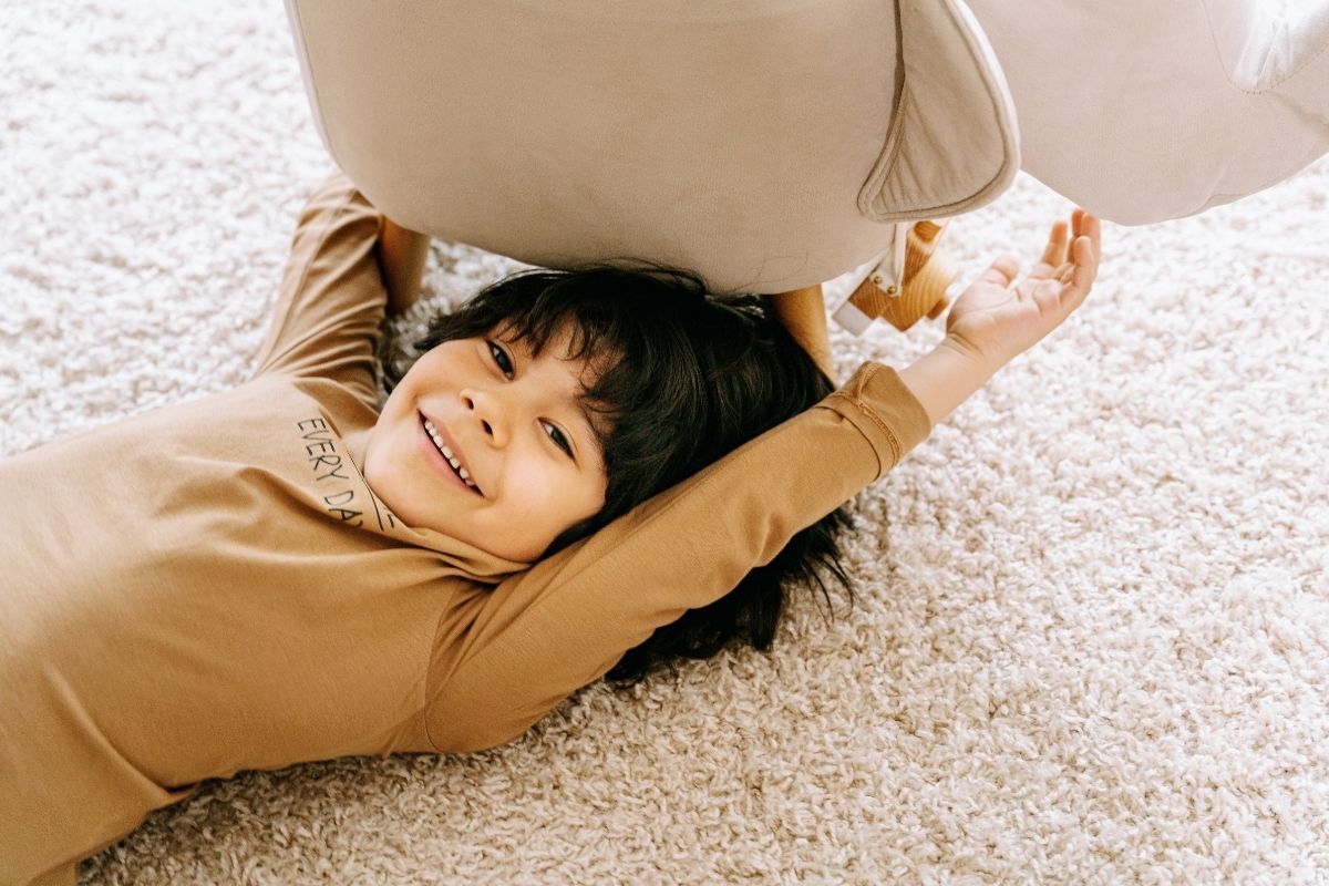 kid lying on clean carpet