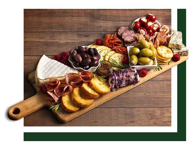 A custom charcuterie board covered in a variety of charcuterie