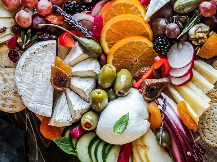 a colorful variety of food on a charcuterie board